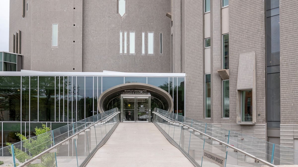 Contemporary architecture of an educational building entrance with bridge in Denver.
