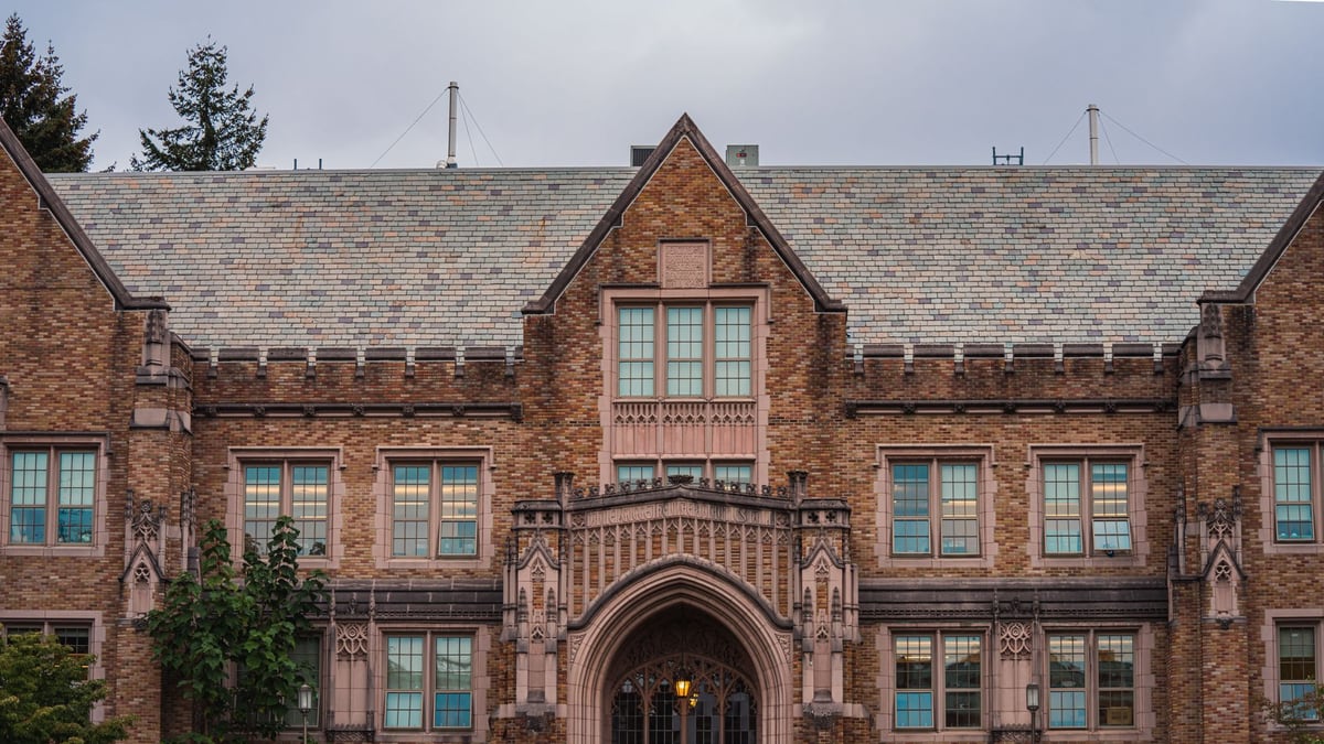 Facade of a historic university building featuring Gothic architecture and ornate stonework.