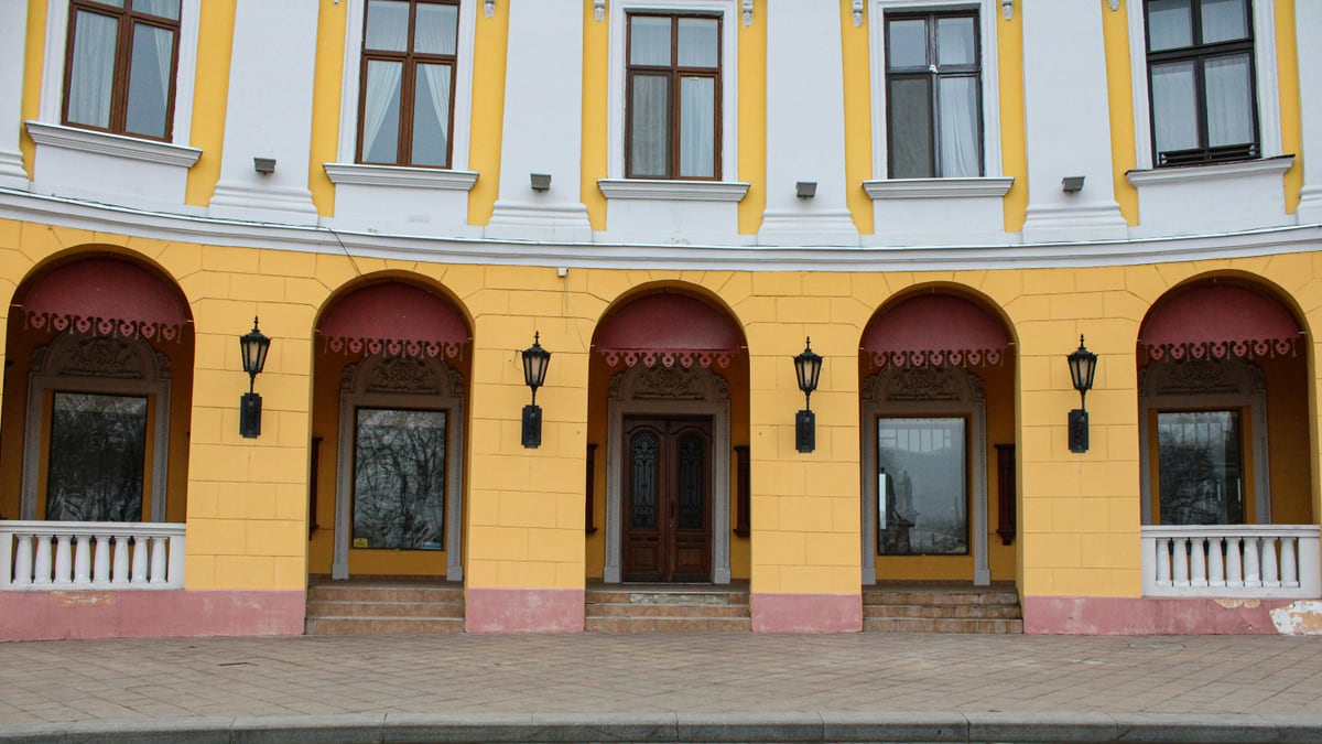 a yellow building with red and white trim