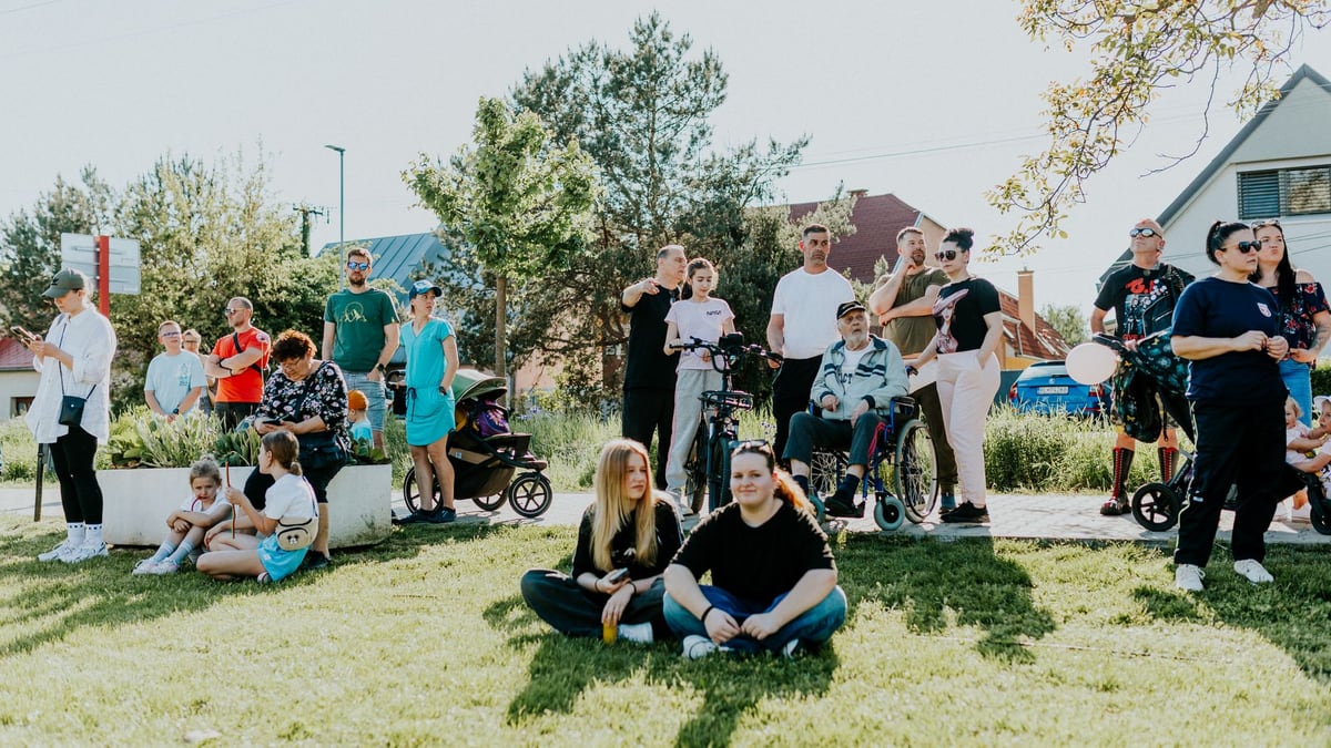 A diverse group enjoying a sunny day outdoors, showcasing community and togetherness.